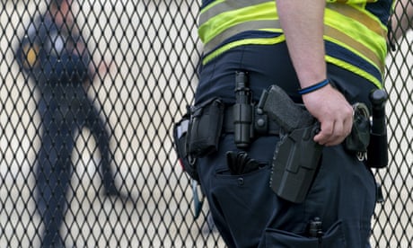 A Capitol Police Officer rests his hand near his gun as he works by the anti-scaling fencing outside the Supreme Court, Thursday, 23 June 2022, in Washington.