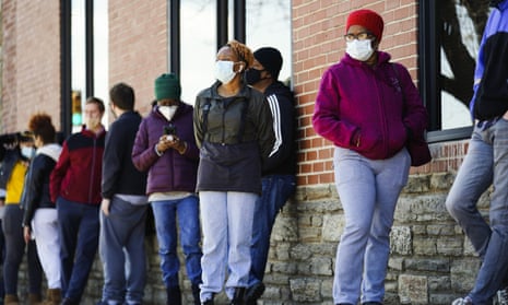People wait in line to receive coronavirus vaccines at a site in Philadelphia on Monday.