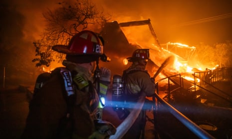 Firefighters fight the flames from the Palisades fire.