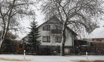 the house said to be connected to the Prague gunman – it is a detached white-painted, three-floor home with a wooden balcony, tiled roof and pointed eaves; there are trees outside, and the house is covered in a light dusting of snow