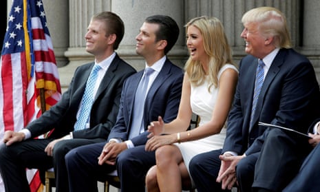 Trump with sons Eric and Donald Jr and daughter Ivanka at the ground-breaking of the Trump hotel in 2014. The hotel became a magnet for controversy.