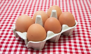 half a dozen eggs in a carton on a table