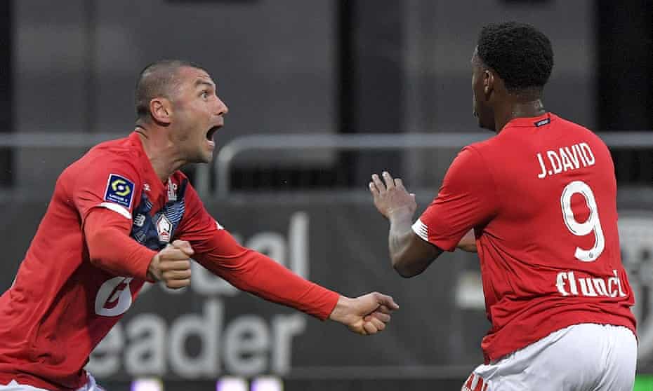 Jonathan David and Burak Yilmaz celebrate Lille's goal against Angers.