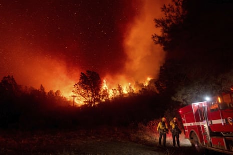Firefighters watch the Bear fire, a smaller blaze that became part of the North Complex fire, approach in Oroville, California, on 9 September. 