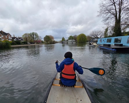 A woman in a canoe holding a padel