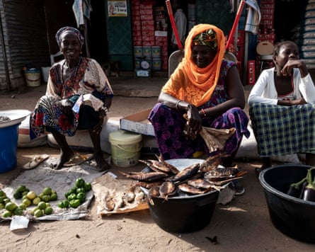 Fish sellers wait for customers at a fish market in the Gambia.