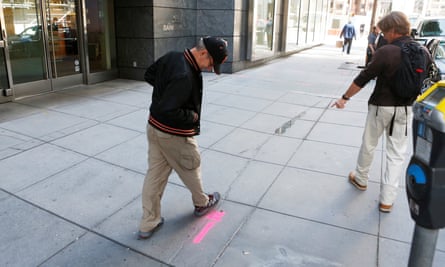 Pedestrians inspect cracks near the sinking Millennium Tower in San Francisco.