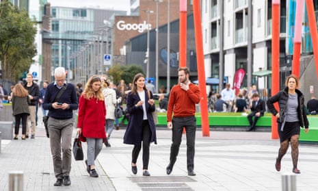 People take a lunch break in the business and financial sector of Dublin City centre with the Google offices in the background on 7 October 2021. 