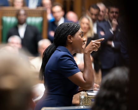Kemi Badenoch speaking during prime minister's questions in the House of Commons. She is seen in profile and looks animated with one hand raised, pointing one finger in front of her.