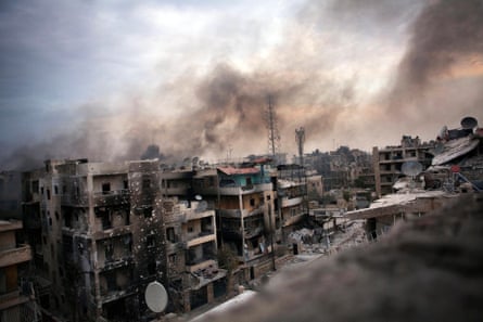 Smoke billows over shelled and destroyed buildings in Saif al-Dawla district, Aleppo, Syria. The Syrian army continued its shelling in the city and brought in reinforcements to try to put an end to the rebels’ resistance. 2 October 2012.