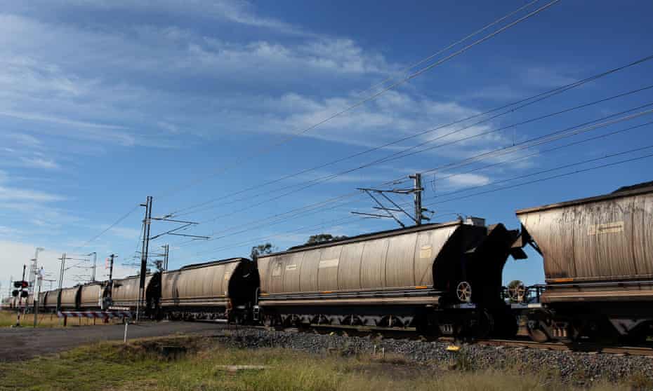 black train cars against a blue sky