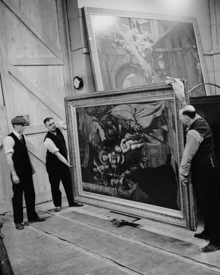 Black and white picture showing two men holding a large renaissance painting as another man looks on