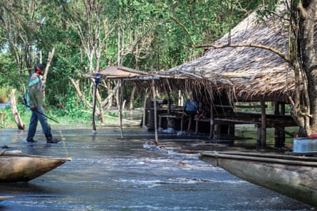 A fisherman visits his family in a village where the houses are built on stilts because of the high tides.