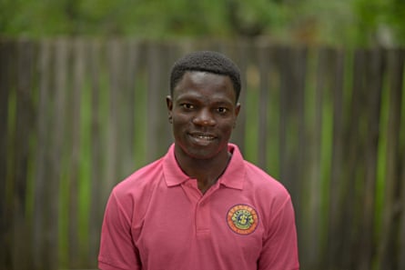 A young African man smiles at the camera