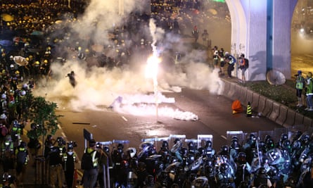 Protesters are engulfed by teargas during a confrontation with riot police in Hong Kong on Sunday.