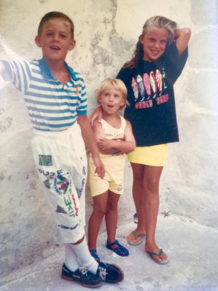 Nicholas Brandram, Alexia Hicks and Sophie Voelcker smiling next to a wall while on holiday