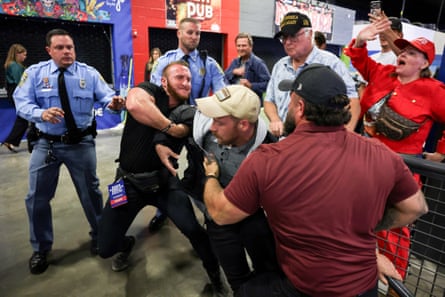 A protester is removed as Trump speaks at during the rally