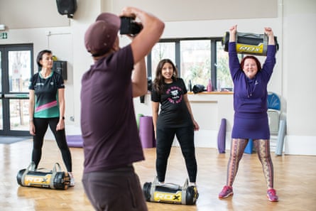 Jason Alfred-Palmer takes a photo of the We Are Fit Attitude class, which includes his mum, Hilary Palmer, 61 (right).