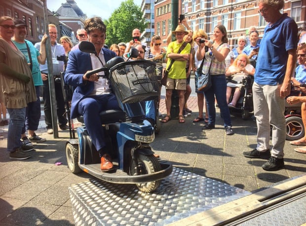 Paul Depla, the mayor of Breda, tries a ramp designed to make the city accessible to people who use wheelchairs.