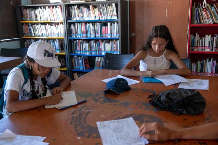 Back at the library, children draw the petroglyphs they discovered on the early morning visit.