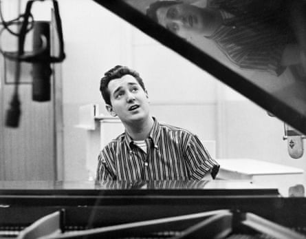 Singer Neil Sedaka seated at a piano.