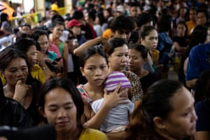 A woman and baby among a large crowd