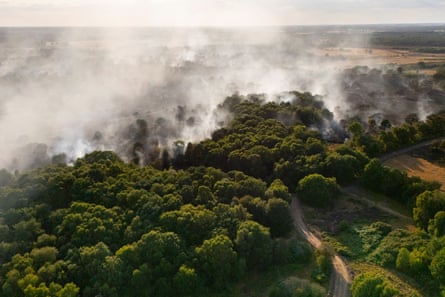 Smoke engulfs and rises from wooden area near Dunwich Heath, Suffolk.