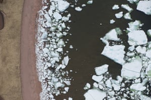 Melting pack ice crowds into a beach on a cove near L’Anse-au-Loup, Labrador.