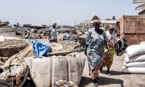 Workers of the fish drying industry walk in the the deserted fish market in Rufisque, Senegal, 2020. 