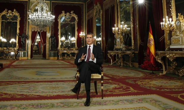 Spain’s King Felipe VI sits on a chair in the royal palace in Madrid