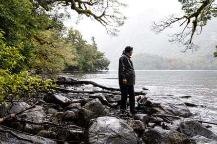 Thomas Mattern stands at the edge of a fjord on a rainy day