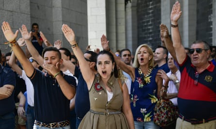 People make the fascist salute at the Valley of Fallen in 2018.