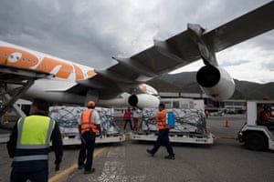 Venezuelan health workers disinfect packages during the arrival of 100,000 doses of the Russian Sputnik V vaccine at the Simon Bolivar International Airport in La Guaira, Venezuela on 13 February, 2021.