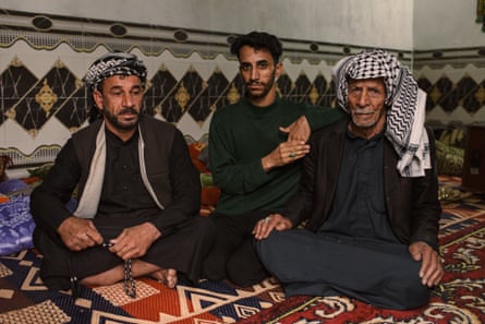 Three Arab men, one middle-aged, one young man