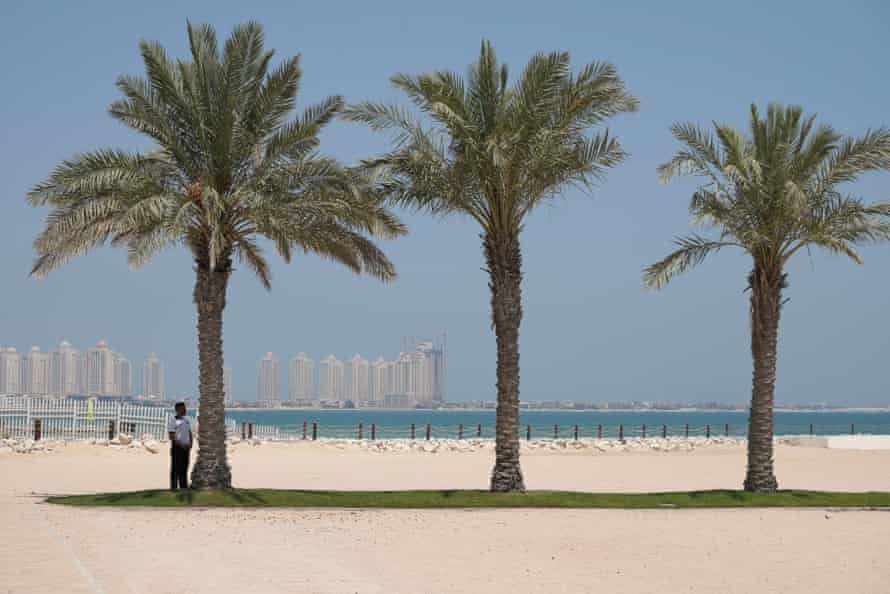 A security guards stands in the shade at a five-star hotel in Doha