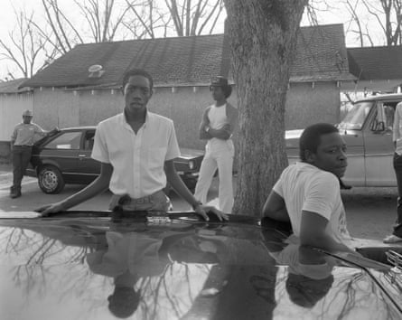 Two black men in shirts leaning against a car in DeFuniak Springs, Florida, 1984