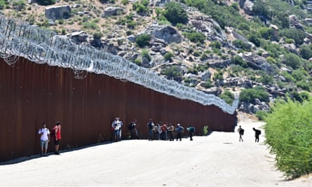 Migrants at the border wall