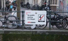 A sign warning visitors not to pee into the canal in the Red Light District of Amsterdam