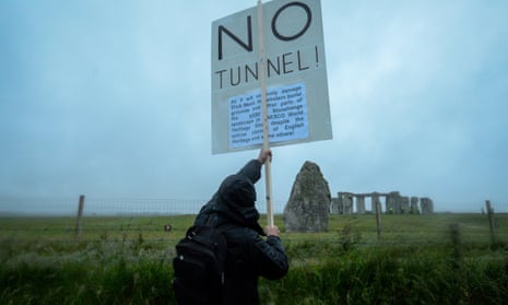 A protester holding a placard opposing the building of a tunnel at Stonehenge earlier this year.