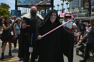 Star Wars fans in costume brandish costume lightsabers