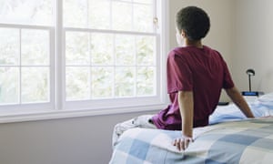 Boy staring out of window.