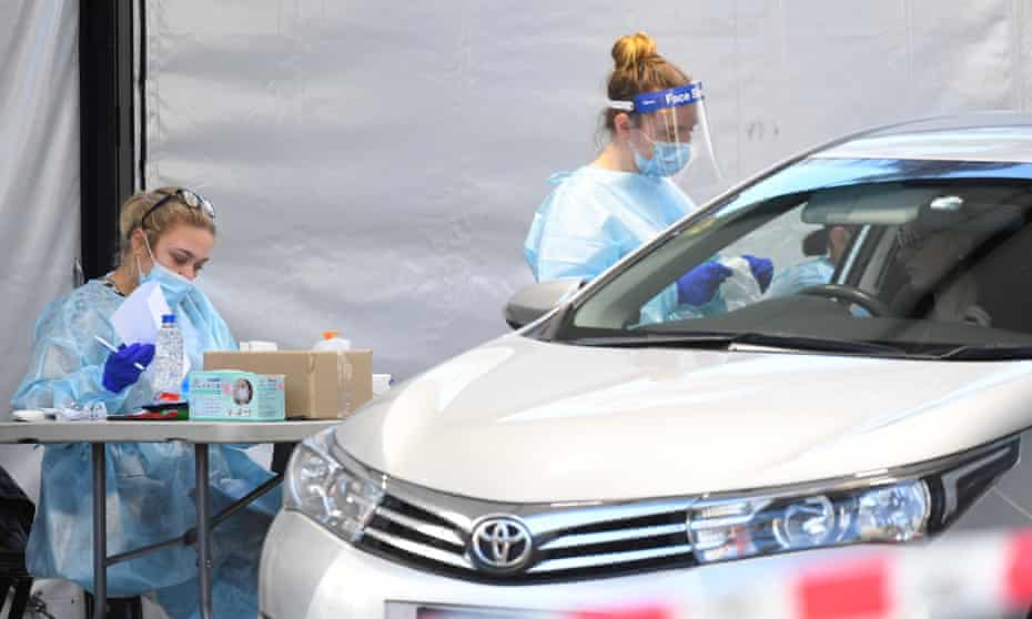 Healthcare workers carry out swab tests at a makeshift drive-through Covid-19 testing facility in Keilor, Melbourne, on Wednesday. Twelve new testing sites will be established across the 36 hotspot suburbs as Victoria imposes new localised lockdowns. 