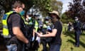 A protester is questioned during a freedom protest in Melbourne, held in response to the government’s Covid-19 restrictions.