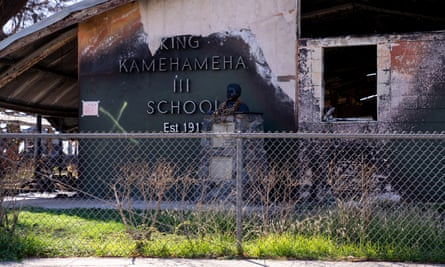 A sign with the name of the school remains on the wall of the destroyed building