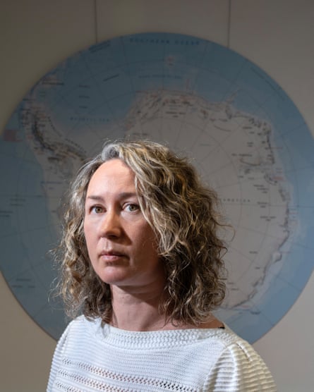 Louise Sime stood in front of a map of Antarctica