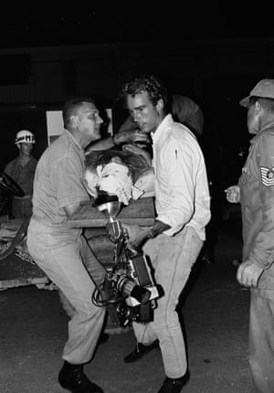 Tim Page, head bandaged, is put into an ambulance jeep in Da Nang, South Vietnam, 23 May 1966