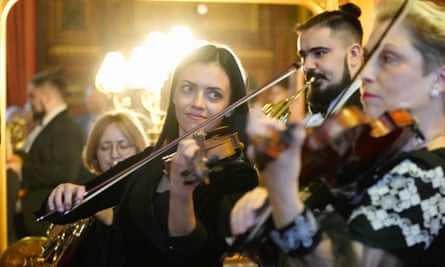 Violinist Viktoria Hanapolska, center, and other musicians from the national Symphony Orchestra of Ukraine play at Speakers House, in London.