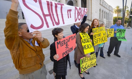 Residents and supporters stand outside Los Angeles city hall during a demonstration ahead of the testimony before the city council on the ongoing leak.