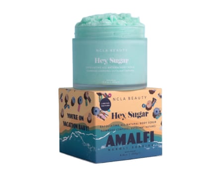 NCLA Beauty Hey, Sugar Amalfi Coast Neroli Body Scrub pot on top of its packaging box. The scrub is aqua coloured and the packaging features an illustration of the Almafi coast.