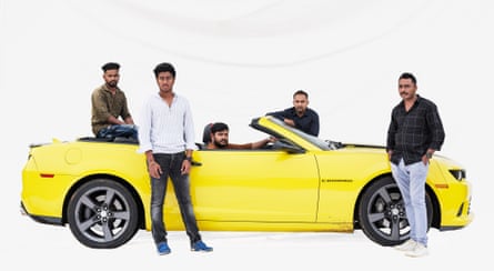 Mechanic Revi, entrepreneur Gyan, manager Praveen, sales executive Mohammed, and investor Rakesh with a Chevrolet in Bengaluru, India. Pne of them is sat in the convertible’s driving seat while the others are stood around it